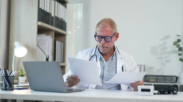 Professional doctor reviewing medical records with focused precision, analyzing patient data in contemporary clinical workspace