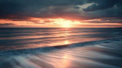 Fototapeta premium The ocean at sunset with beautiful golden and dark clouds