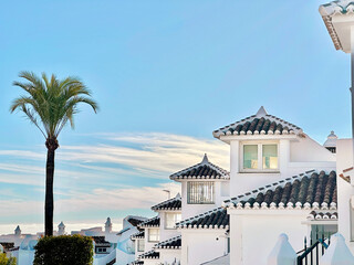 Obraz premium Blue Cloudy Sunset Sky Over Spain Authentic Architecture With Exotic Palm Trees