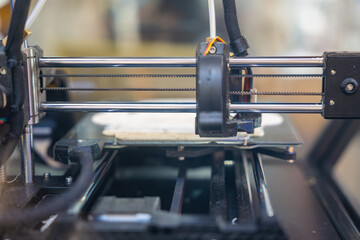 3D printer creating plastic objects with precision and speed. The concept represents modern...
