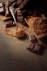 Broken bitter chocolate bar and cocoa powder.