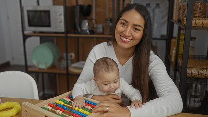 Obraz premium Woman smiling with baby playing in living room interior showcasing family love and togetherness.