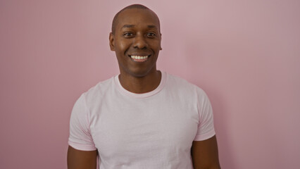 Young man smiling against isolated pink background showcasing attractive confidence style and positivity inspiring vibrant energy