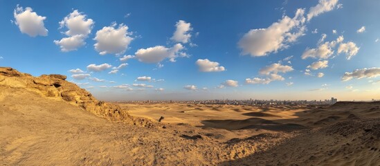 Naklejka premium A vast desert landscape with a blue sky and fluffy white clouds