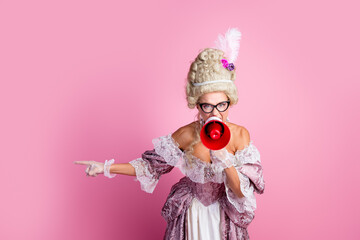 Woman in Historical Costume Holding a Megaphone Against a Pink Background