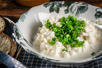 Slices of bread with cottage cheese and green onion.