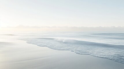 A serene view of the calm ocean meeting a sandy shore