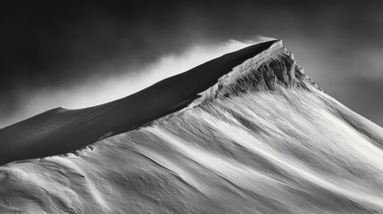 A dramatic black and white photograph of a snow covered mountain