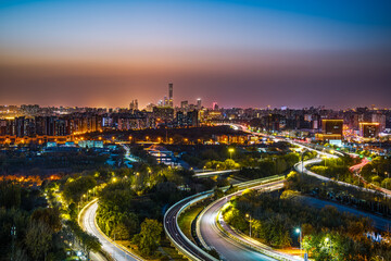 Fototapeta premium The road shining with brilliant lights in the urban night view of Beijing, China