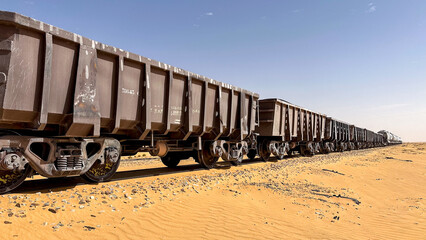 Perspective view of ore wagons on a train in the desert of Mauritania