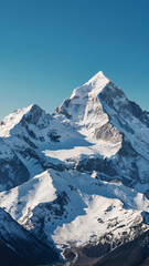 The image shows a majestic snow capped mountain peak against a clear blue sky. 