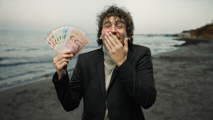 Man laughing holding thai banknotes on a beach seaside backdrop, embodying travel and financial...