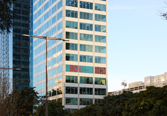 A real estate advertisement displayed prominently on the facade of an office skyscraper located in Barcelona, Spain.