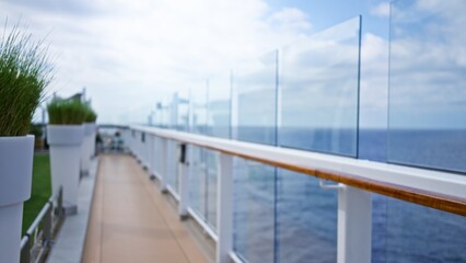 Obraz premium Blurred cruise deck with defocused luxury outdoors and bokeh effect, showcasing a tranquil and relaxing atmosphere at sea on a sunny day.