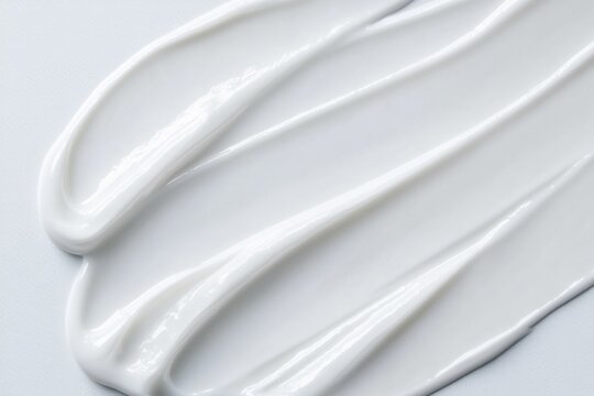 White lotion or skincare cream texture spread smoothly, cosmetic moisturizer background for beauty and skincare products
