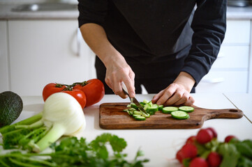 Preparing healthy food or a salad. Fresh vegetables and herbs on the table. 