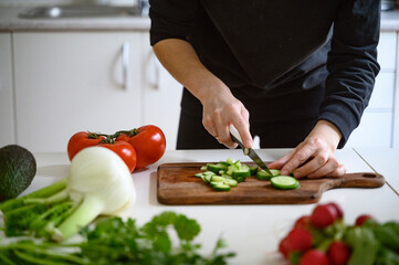Preparing healthy food or a salad. Fresh vegetables and herbs on the table. 