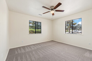 Spacious living room with wooden flooring and sliding doors leading to a bright outdoor area