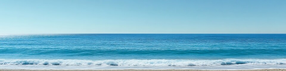 Obraz premium Tranquil beachscape with gentle waves and an endless clear blue sky