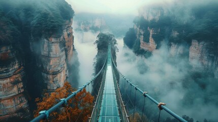Fototapeta premium Majestic Suspension Bridge Surrounded by Misty Mountain Landscapes and Lush Greenery in a Serene Environment