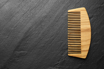 One wooden hair comb on grey background, top view. Space for text
