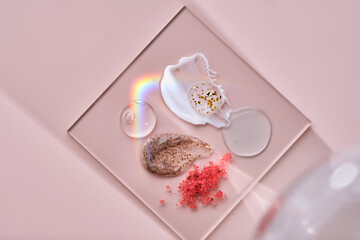 Different textures of skin care products on a square stand with beautiful caustics.