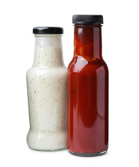 Different delicious sauces in glass bottles isolated on white