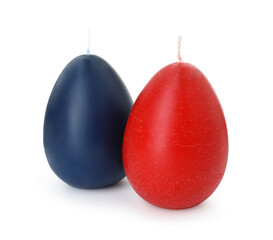Colorful egg-shaped candles isolated on white. Easter decor