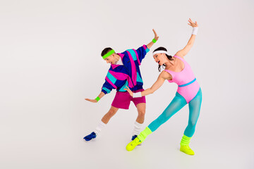 Colorful retro aerobics dance duo energetically exercising on a white background, dressed in vibrant 80s activewear, headbands