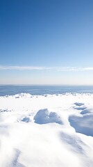 A serene winter landscape showcasing snow and a blue sky