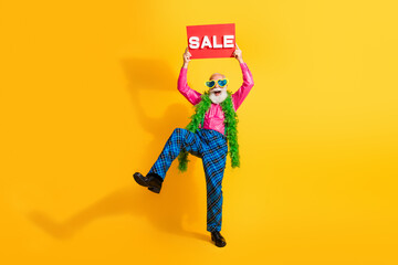 Full length photo of nice senior male have fun hold sale boa wear pink shirt plaid pants suspenders fancy outfit on yellow color background