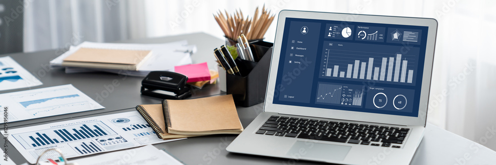 Poster data analysis dashboard display on laptop screen on office table with financial papers by fintech bi