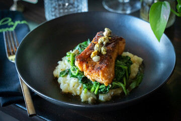 Vegan Salmon over a bed of Mashed Potato and Spinach, topped with Capers.