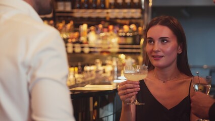 Focusing beautiful woman lively talking with friends while enjoy drinking Margarita cocktail at luxurious counter bar nightclub creating vibrant engaging atmosphere on Friday night meeting. Vinosity.