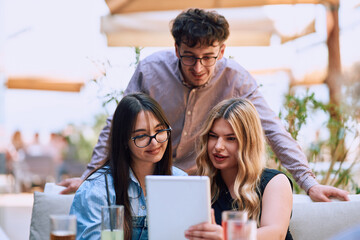 A Diverse MultiEthnic Group Reviewing Projects During a Work Break in a Caffee.
