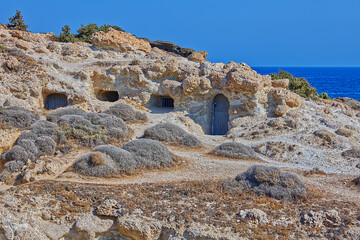 Caves in the rocks and cliffs with door and windows