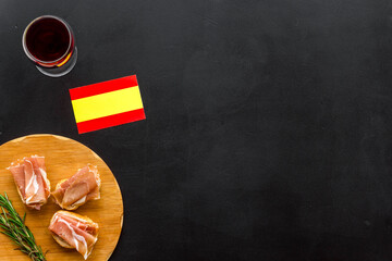 Welcome to Spain. Parma ham and Spanish flag, top view