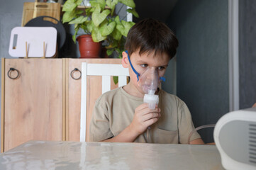 Child is inhaled with a masks nebulizer inhaler to treat a from coughing. Children's health,...