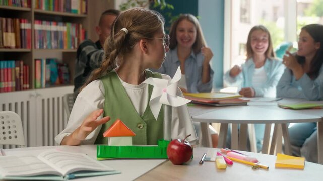 Sad bullied Caucasian girl female child kid teen teenager pupil at school suffer bullying mocking pupils classmates studying problem take off glasses put palm hand in front stop bully gesture enough