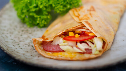 pancakes with salted ham, tomato, herbs and cheese