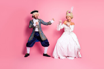 A couple dressed in historical costumes having fun in a themed setting with vibrant colors