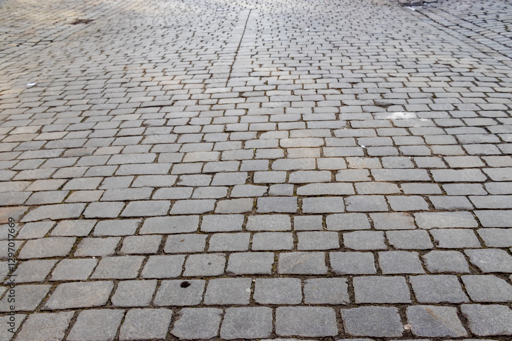Poster stone pavement in a urban setting, ideal for architectural projects or urban design concepts. gray c