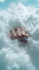Fototapeta premium A hand emerges from fluffy clouds, creating a surreal and dreamlike atmosphere, evoking feelings of mystery and introspection.