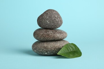 Stack of rocks on light blue background. Harmony and life balance