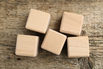Many blank cubes on wooden table, flat lay