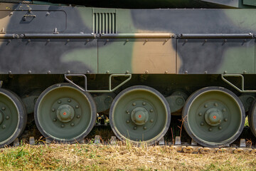 tracks and wheels guiding the tracks on a military vehicle