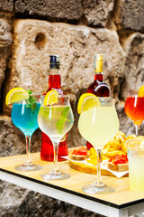Colorful cocktails and appetizers served on table in Naples, Italy