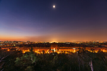 A panoramic view of the night scene of the Palace Museum in Beijing, China, a glorious historical site in the twilight