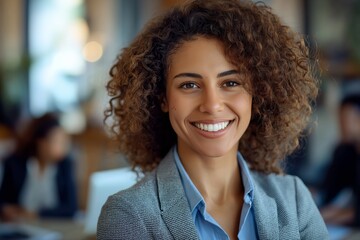 Fototapeta premium Confident businesswoman smiling and posing in a modern office, radiating professionalism and embodying the essence of success in the corporate environment