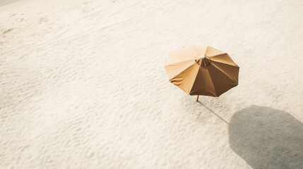 A beach umbrella provides shade on the beautiful white sand